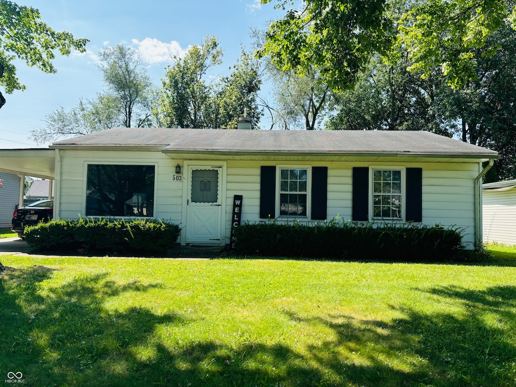 ranch-style home with a front lawn