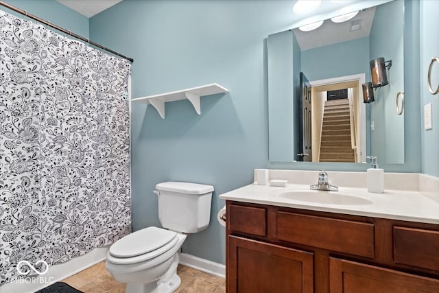 bathroom featuring tile patterned flooring, a shower with curtain, vanity, and toilet