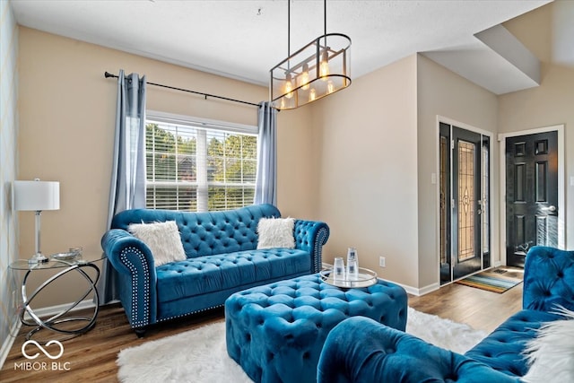 living room featuring a notable chandelier and hardwood / wood-style floors