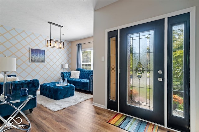 entryway with a textured ceiling and hardwood / wood-style floors