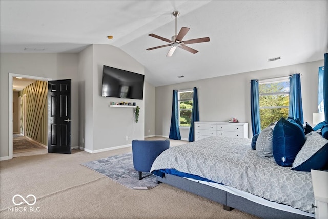 carpeted bedroom featuring ceiling fan, vaulted ceiling, and multiple windows