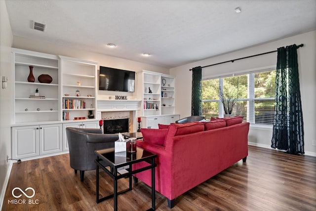 living room featuring a high end fireplace, a textured ceiling, and dark hardwood / wood-style floors