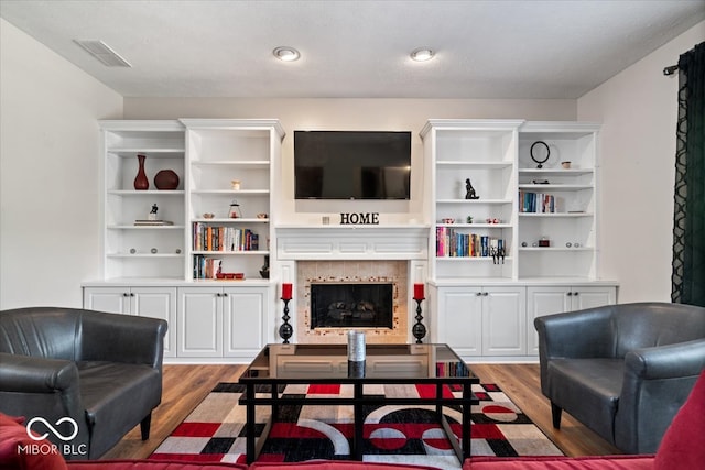 living room featuring light hardwood / wood-style floors and a textured ceiling