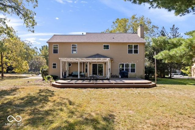 back of house with a wooden deck, a pergola, and a yard