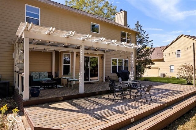 back of house featuring central AC unit, a wooden deck, and a pergola