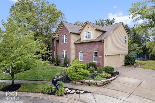 view of front property with a front yard, a garage, and a trampoline