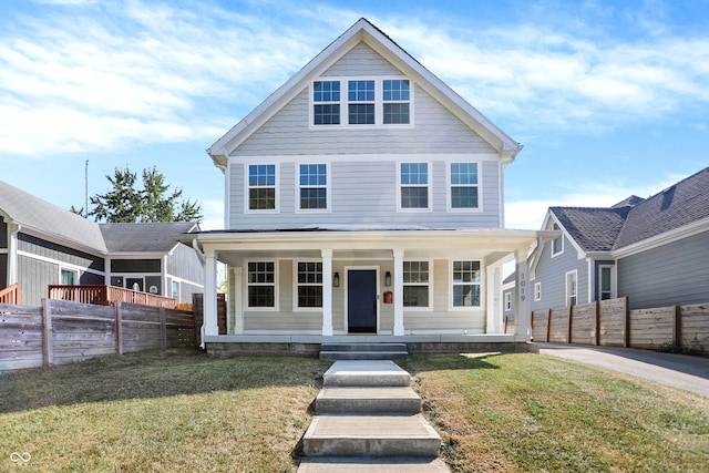 view of front of property with a front yard and covered porch