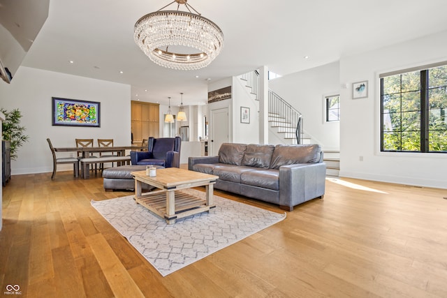 living room featuring light hardwood / wood-style flooring and a chandelier