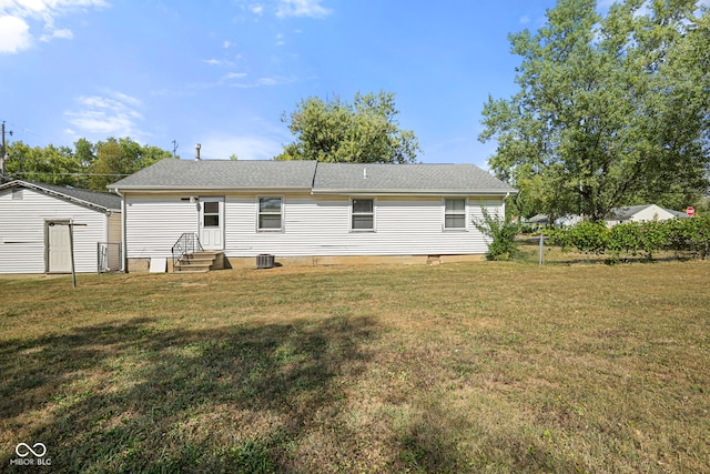 rear view of house with a yard