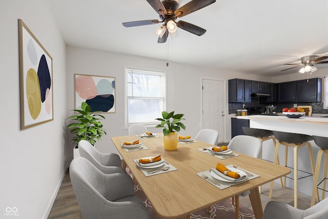 dining area featuring hardwood / wood-style flooring and ceiling fan