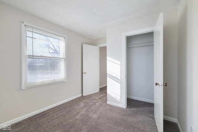 unfurnished bedroom featuring carpet floors and a closet