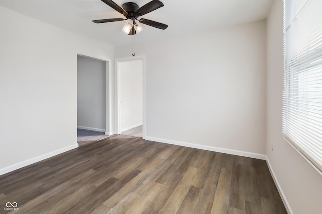 spare room featuring ceiling fan and dark hardwood / wood-style flooring