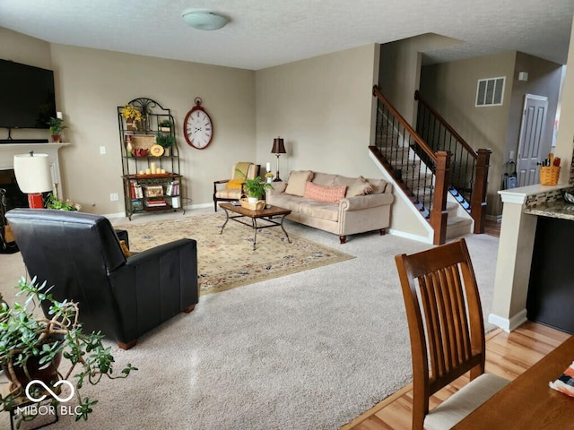 living room featuring a textured ceiling and hardwood / wood-style floors