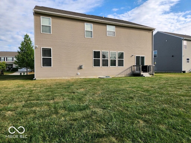 rear view of property with a yard