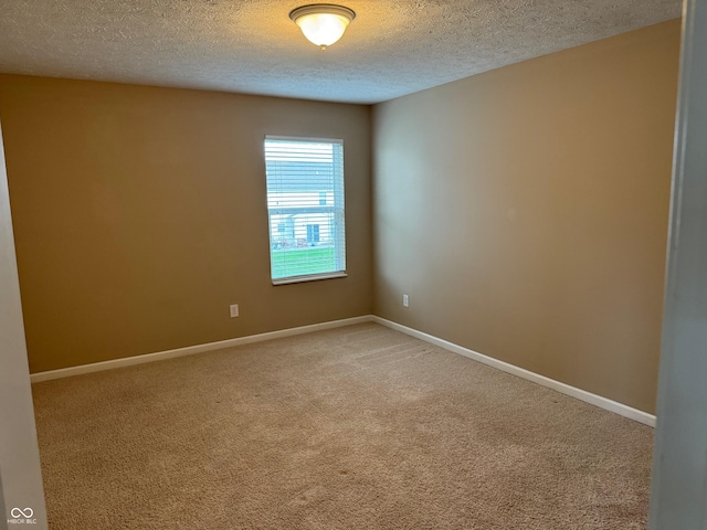 empty room with a textured ceiling and carpet floors