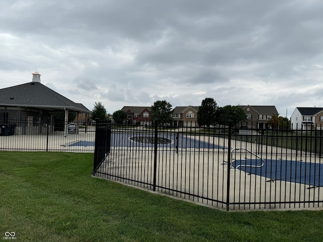 view of swimming pool featuring a yard