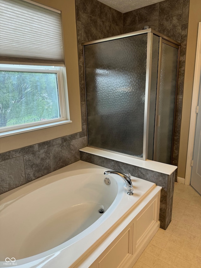 bathroom featuring independent shower and bath