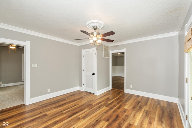 unfurnished bedroom featuring a closet, dark wood-type flooring, crown molding, a textured ceiling, and ceiling fan