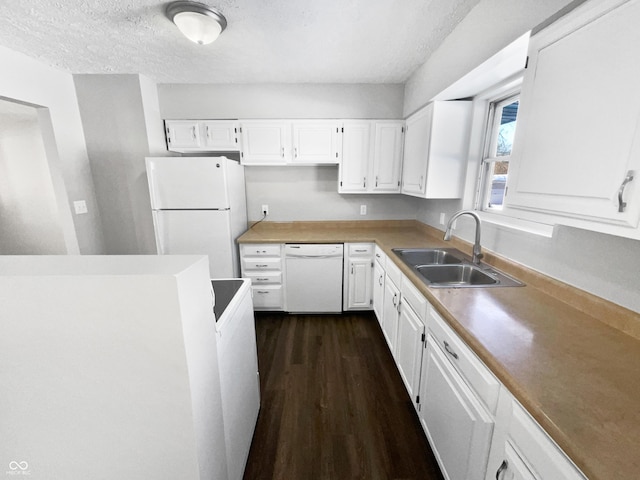 kitchen featuring dark hardwood / wood-style floors, sink, white appliances, a textured ceiling, and white cabinets