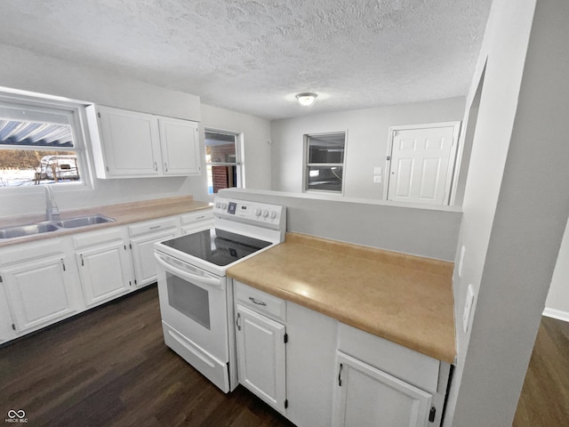 kitchen featuring a textured ceiling, white electric range, dark wood-type flooring, white cabinetry, and sink