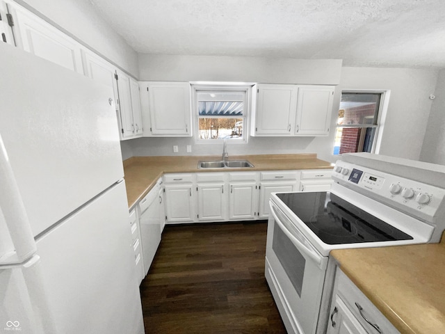 kitchen featuring white appliances, white cabinets, a textured ceiling, sink, and dark hardwood / wood-style floors