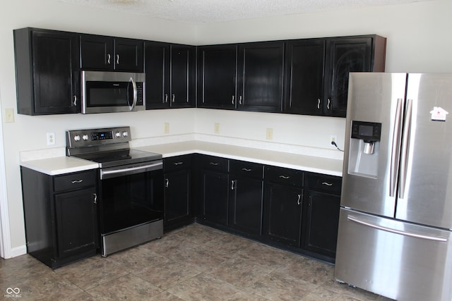 kitchen featuring appliances with stainless steel finishes and a textured ceiling