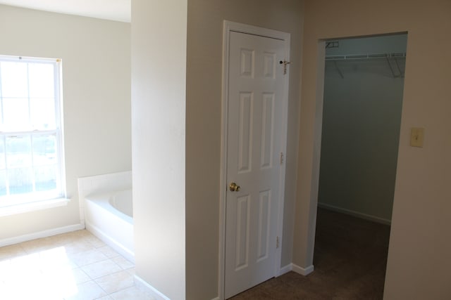 bathroom featuring tile patterned flooring and a bathtub