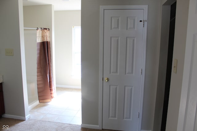 corridor with light tile patterned flooring