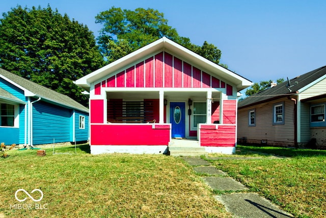 view of front of house with a porch and a front yard