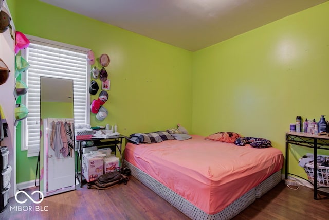 bedroom with hardwood / wood-style floors