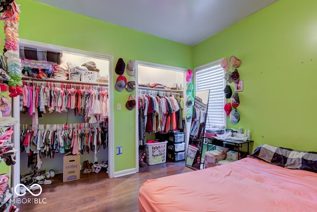 bedroom with dark hardwood / wood-style flooring