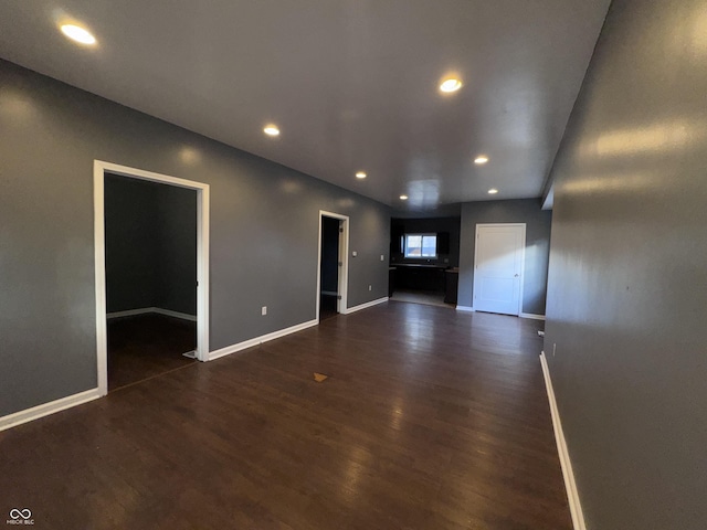 unfurnished living room featuring dark hardwood / wood-style flooring