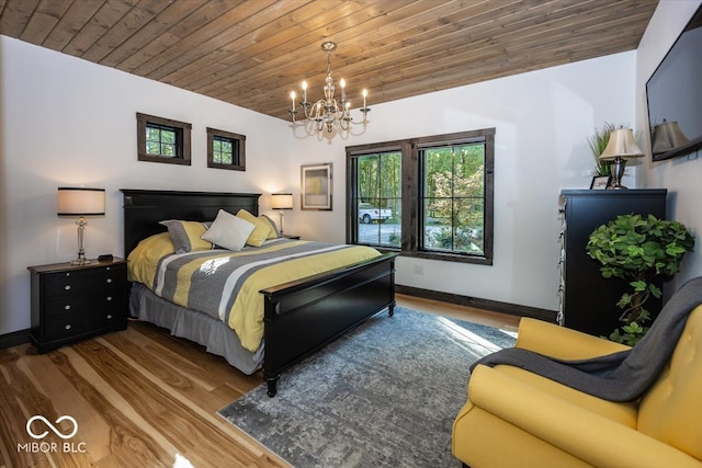 bedroom with an inviting chandelier, wood ceiling, and dark hardwood / wood-style floors