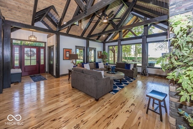 living room featuring light wood-type flooring, high vaulted ceiling, and a wealth of natural light