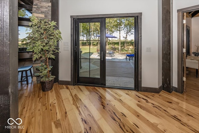 entryway with hardwood / wood-style floors and french doors