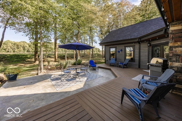 wooden terrace featuring a grill