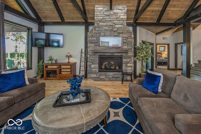 living room with a stone fireplace, wood-type flooring, wood ceiling, and beamed ceiling