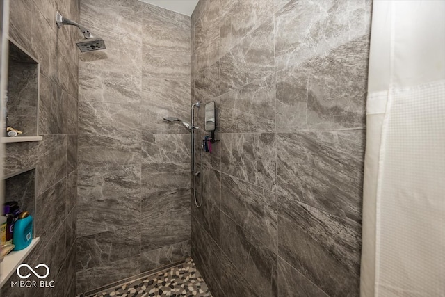 bathroom with a tile shower