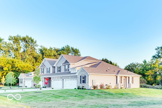 view of front of house with a garage and a front lawn