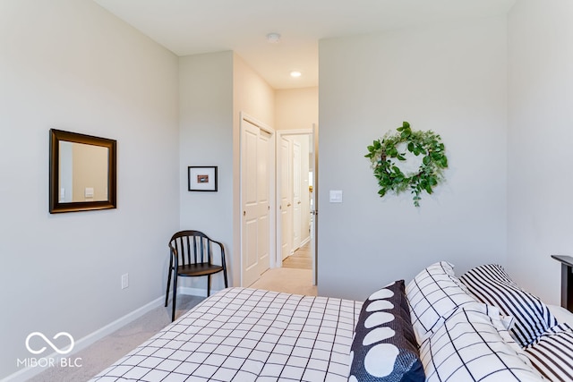 bedroom featuring a closet and light colored carpet