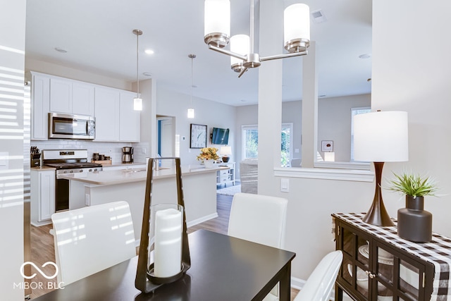 dining room featuring a chandelier and hardwood / wood-style flooring