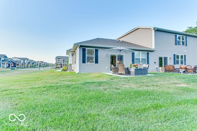 rear view of property with a lawn