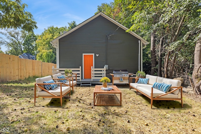 rear view of property featuring an outdoor living space