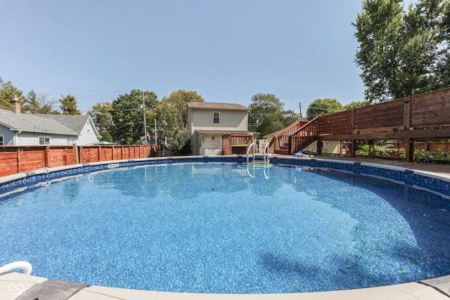 view of swimming pool featuring an outbuilding and a wooden deck