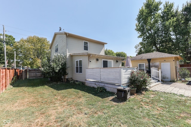 rear view of property with a lawn