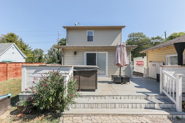 rear view of property featuring a deck