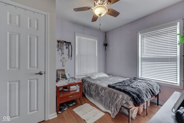 bedroom featuring ceiling fan and light hardwood / wood-style flooring