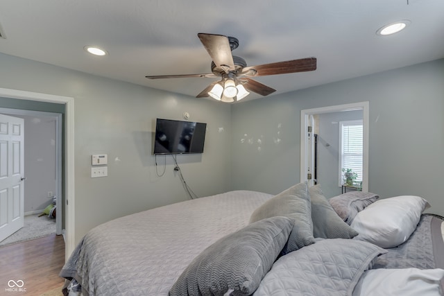 bedroom with ceiling fan and hardwood / wood-style floors