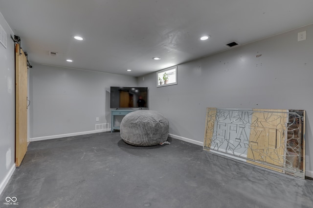 unfurnished room featuring a barn door