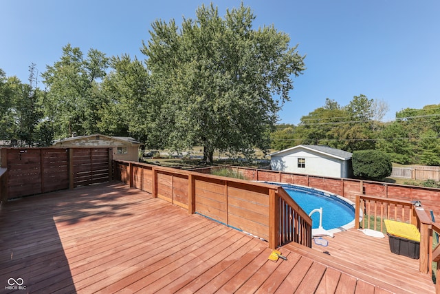 deck featuring a fenced in pool